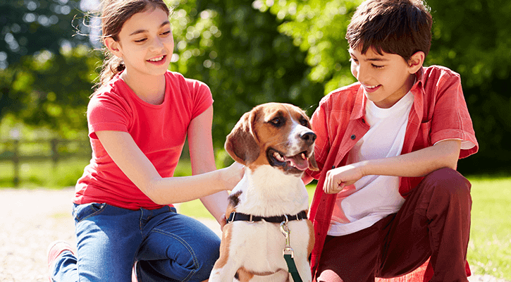 dog between two children